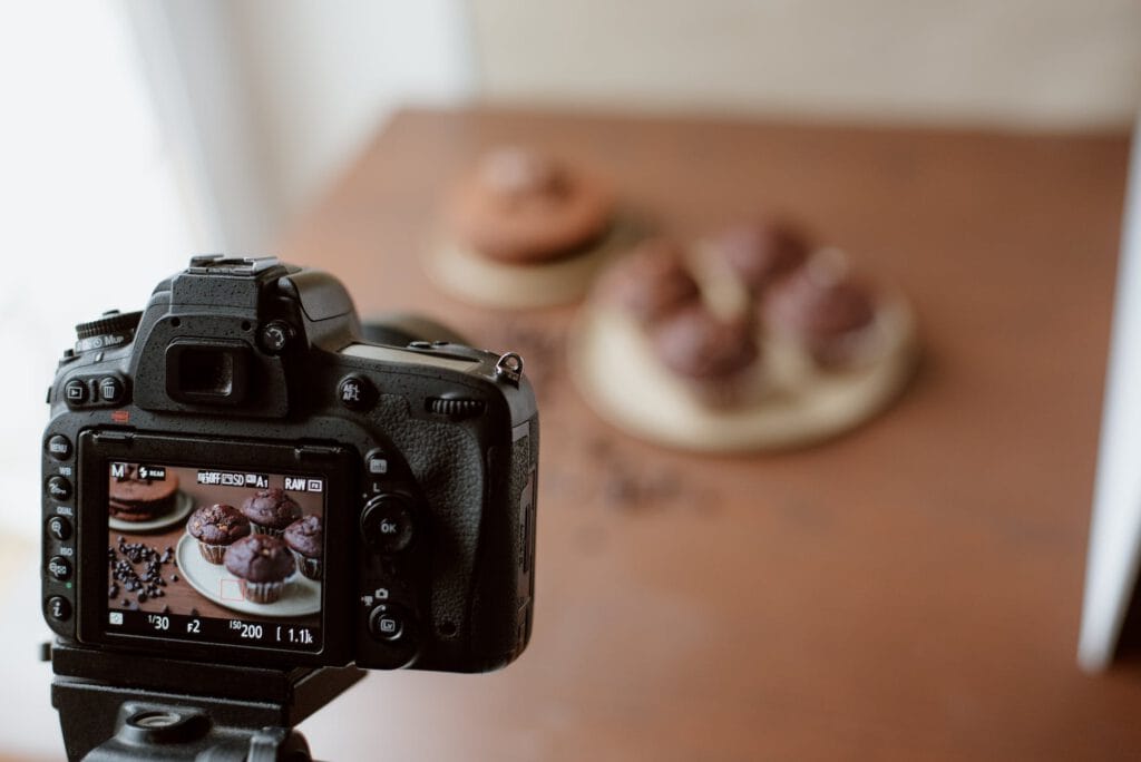 pexels-photo-4792399 screen of photo camera with photo of chocolate cupcakes
